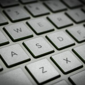 A detailed macro shot of a sleek modern computer keyboard featuring the QWERTY layout.